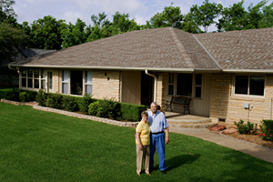 reverse mortgage couple in front of house